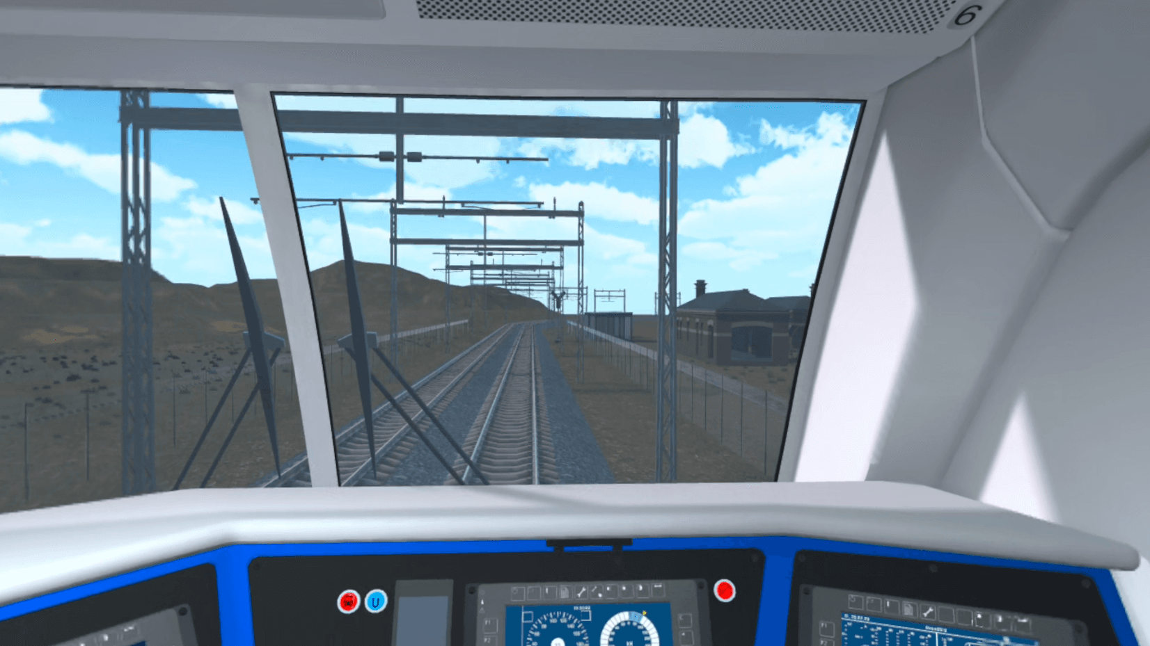 A first-person view from a locomotive cab looking out over open track under a clear sky.